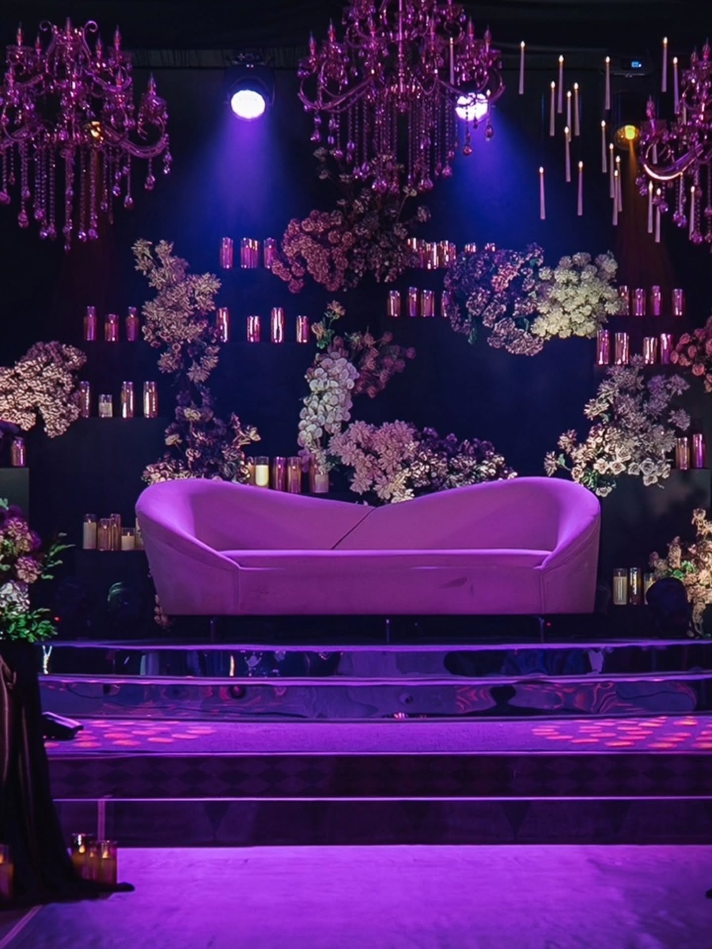Luxury floral wedding stage with chandeliers and lounge seating