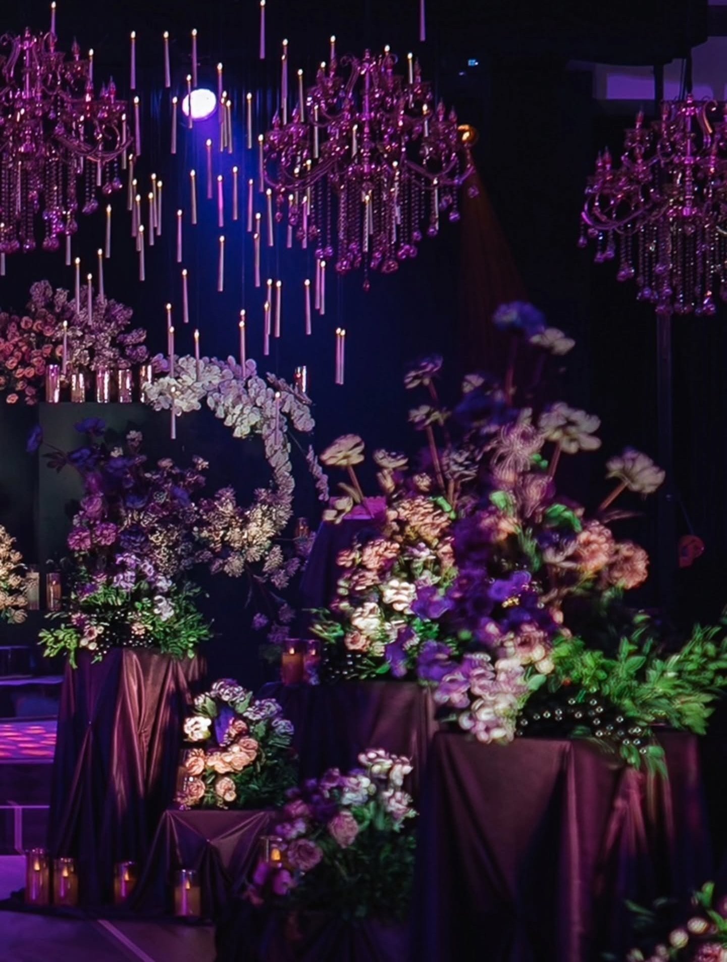 Luxury indoor event venue with floral installations and chandeliers